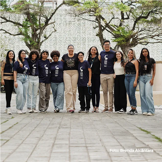Equipe da exposição posa em grupo ao ar livre